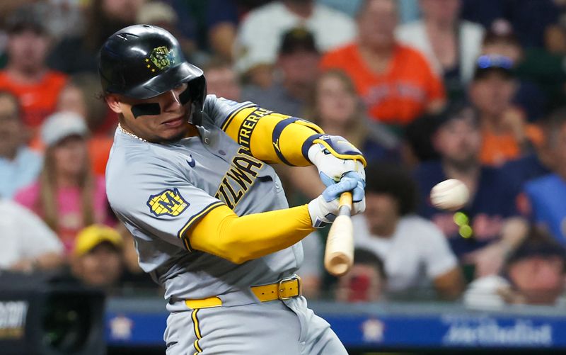 May 18, 2024; Houston, Texas, USA; Milwaukee Brewers catcher William Contreras (24) hits a three-run home run against the Houston Astros in the fifth inning at Minute Maid Park. Mandatory Credit: Thomas Shea-USA TODAY Sports