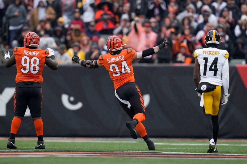 Cincinnati Bengals' Sam Hubbard (94) and DJ Reader (98) react as Pittsburgh Steelers wide receiver George Pickens (14) looks on during a NFL football game, Sunday, Nov. 26, 2023, in Cincinnati. (AP Photo/Jeff Dean)