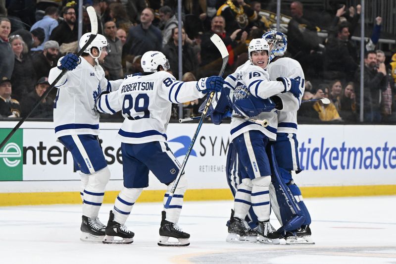 Feb 25, 2025; Boston, Massachusetts, USA; Toronto Maple Leafs right wing Mitch Marner (16) celebrates with his teammates after scoring the game winning goal against the Boston Bruins during an overtime period at the TD Garden. Mandatory Credit: Brian Fluharty-Imagn Images