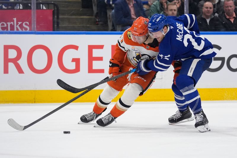 Mar 12, 2026; Toronto, Ontario, CAN; Toronto Maple Leafs defenseman Jake McCabe (22) and Anaheim Ducks forward Cutter Gauthier (61) battle for the puck during the second period at Scotiabank Arena. Mandatory Credit: John E. Sokolowski-Imagn Images