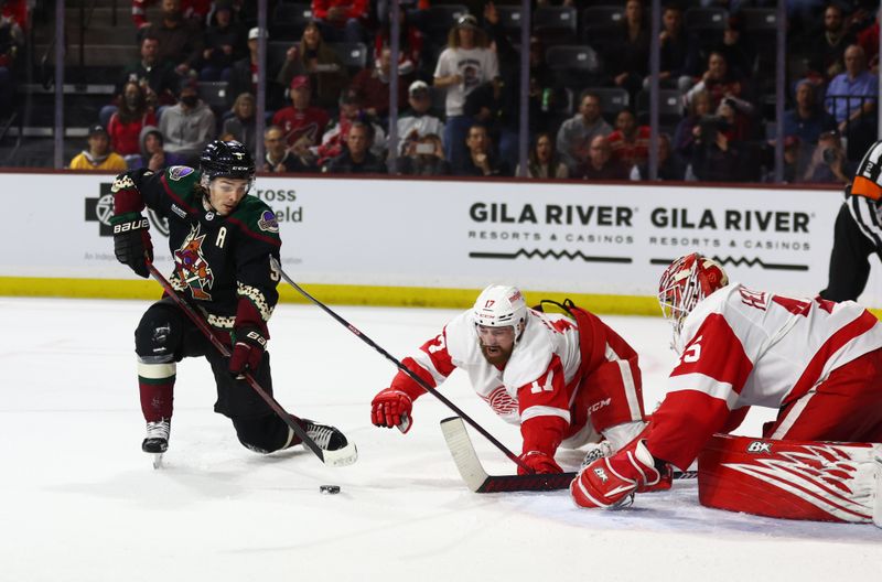 Jan 17, 2023; Tempe, Arizona, USA; Arizona Coyotes right wing Clayton Keller (9) attempts a shot against Detroit Red Wings defenseman Filip Hronek (17) and goalie Magnus Hellberg (45) in overtime at Mullett Arena. Mandatory Credit: Mark J. Rebilas-USA TODAY Sports