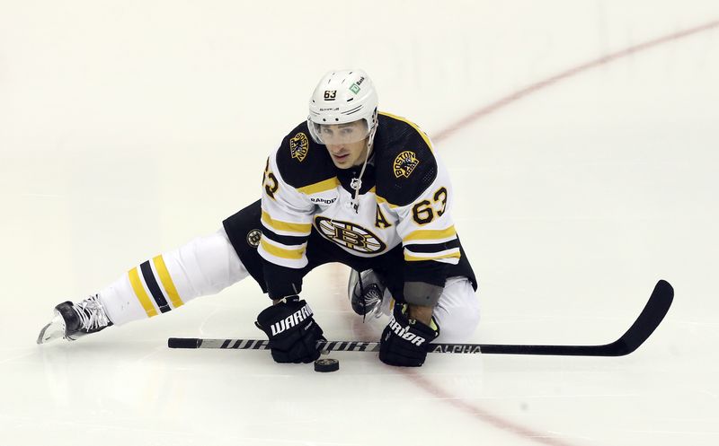 Nov 1, 2022; Pittsburgh, Pennsylvania, USA;  Boston Bruins  left wing Brad Marchand (63) stretches on the ice to warm up before the game against the Pittsburgh Penguins at PPG Paints Arena. Mandatory Credit: Charles LeClaire-USA TODAY Sports