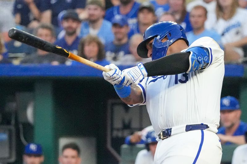 Aug 19, 2024; Kansas City, Missouri, USA; Kansas City Royals catcher Salvador Perez (13) hits an RBI single against the Los Angeles Angels in the third inning at Kauffman Stadium. Mandatory Credit: Denny Medley-USA TODAY Sports