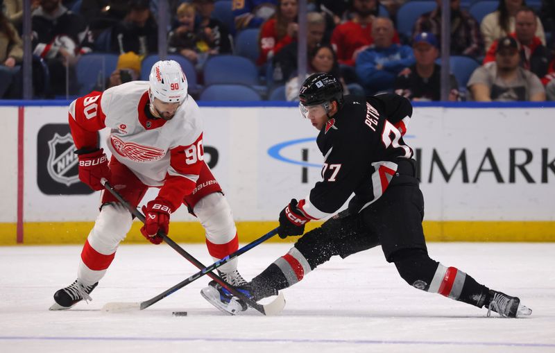 Oct 26, 2024; Buffalo, New York, USA;  Detroit Red Wings center Joe Veleno (90)and Buffalo Sabres right wing JJ Peterka (77) battle for a loose puck during the first period at KeyBank Center. Mandatory Credit: Timothy T. Ludwig-Imagn Images