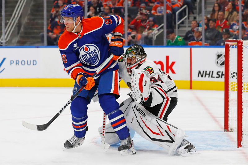 Oct 12, 2024; Edmonton, Alberta, CAN; Edmonton Oilers forward Corey Perry (90) tries to screen  Chicago Blackhawks goaltender Petr Mrazek (34) during the third period at Rogers Place. Mandatory Credit: Perry Nelson-Imagn Images