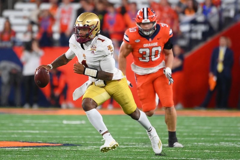 Nov 3, 2023; Syracuse, New York, USA; Boston College Eagles quarterback Thomas Castellanos (1) runs with the ball as Syracuse Orange defensive lineman Chase Simmons (30) chases during the second half at the JMA Wireless Dome. Mandatory Credit: Rich Barnes-USA TODAY Sports