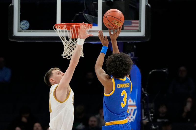 Mar 11, 2025; Charlotte, NC, USA; Pittsburgh Panthers guard Brandin Cummings (3) shoots asNotre Dame Fighting Irish guard Matt Allocco (41) defends in the first half at Spectrum Center. Mandatory Credit: Bob Donnan-Imagn Images