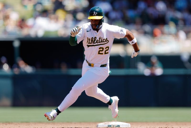May 22, 2025; West Sacramento, California, USA; Athletics designated hitter Miguel Andujar (22) advances to third base on a single by third baseman Gio Urshela (13) during the third inning against the Los Angeles Angels at Sutter Health Park. Mandatory Credit: Sergio Estrada-Imagn Images