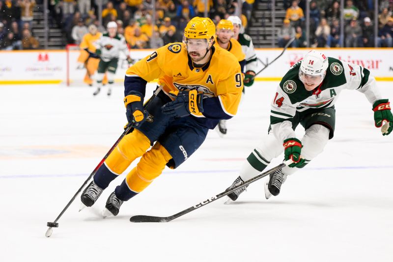 Jan 18, 2025; Nashville, Tennessee, USA;  Nashville Predators left wing Filip Forsberg (9) skates past Minnesota Wild center Joel Eriksson Ek (14) during the third period at Bridgestone Arena. Mandatory Credit: Steve Roberts-Imagn Images