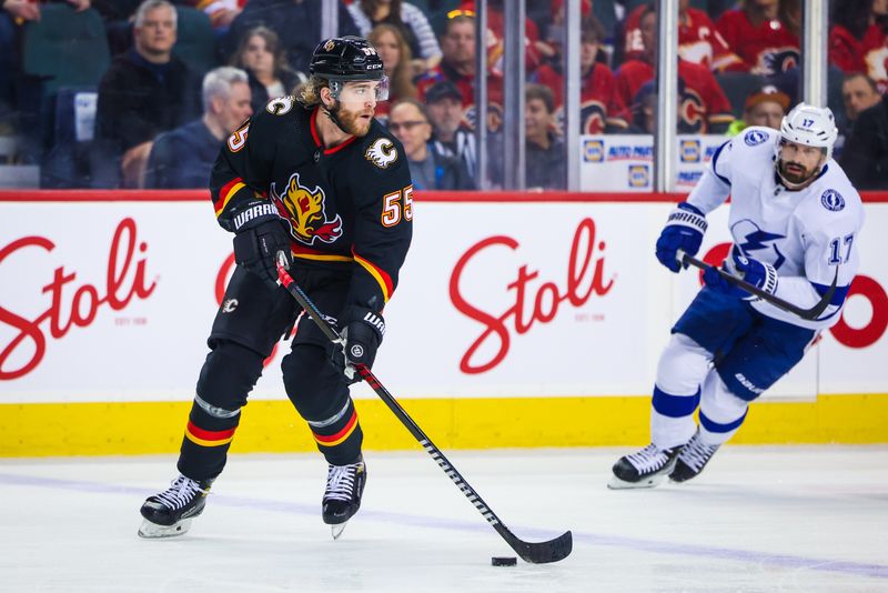 Jan 21, 2023; Calgary, Alberta, CAN; Calgary Flames defenseman Noah Hanifin (55) controls the puck against the Tampa Bay Lightning during the first period at Scotiabank Saddledome. Mandatory Credit: Sergei Belski-USA TODAY Sports