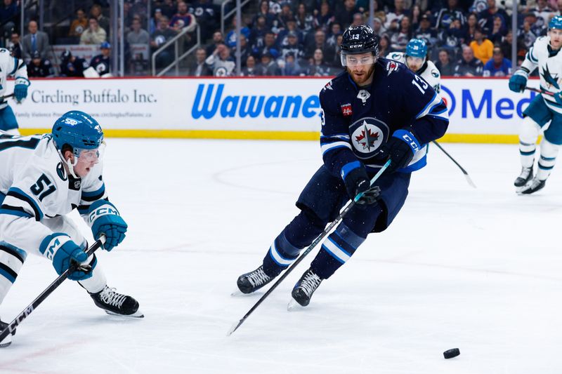 Feb 24, 2025; Winnipeg, Manitoba, CAN;  Winnipeg Jets forward Gabriel Vilardi (13) skates away from San Jose Sharks forward Collin Graf (51) during the second period at Canada Life Centre. Mandatory Credit: Terrence Lee-Imagn Images