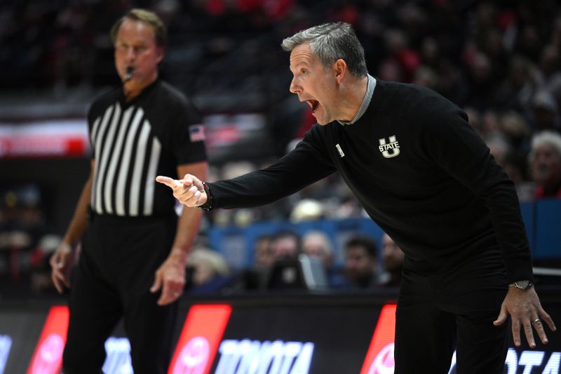 Jan 25, 2023; San Diego, California, USA; Utah State Aggies head coach Ryan Odom (right) gestures from the sideline during the first half against the San Diego State Aztecs at Viejas Arena. Mandatory Credit: Orlando Ramirez-USA TODAY Sports