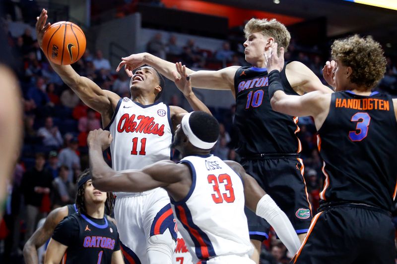 Jan 10, 2024; Oxford, Mississippi, USA; Mississippi Rebels guard Matthew Murrell (11) shoots as Florida Gators forward Thomas Haugh (10) defends during the second half at The Sandy and John Black Pavilion at Ole Miss. Mandatory Credit: Petre Thomas-USA TODAY Sports