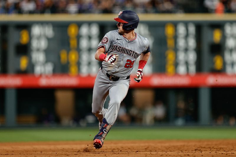 Jun 21, 2024; Denver, Colorado, USA; Washington Nationals right fielder Lane Thomas (28) watches his ball as he runs to third on an RBI triple in the sixth inning against the Colorado Rockies at Coors Field. Mandatory Credit: Isaiah J. Downing-USA TODAY Sports