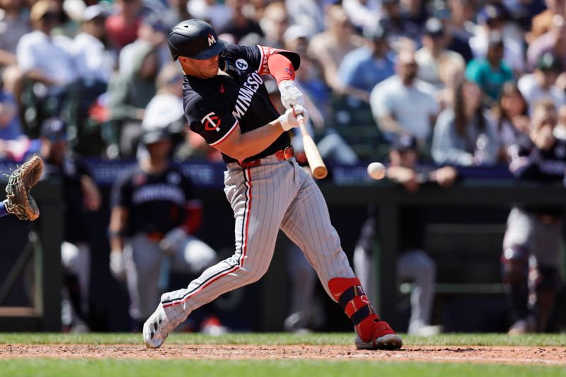 Jun 1, 2025; Seattle, Washington, USA; Minnesota Twins first baseman Ty France (13) singles against the Seattle Mariners during the ninth inning at T-Mobile Park. Mandatory Credit: John Froschauer-Imagn Images