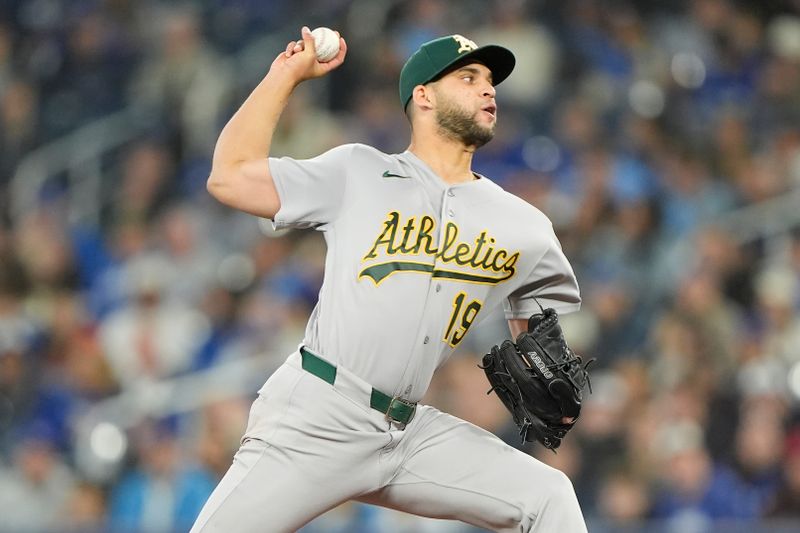 Mar 29, 2026; Toronto, Ontario, CAN; Athletics starting pitcher Luis Morales (19) pitches to the Toronto Blue Jays during the first inning at Rogers Centre. Mandatory Credit: John E. Sokolowski-Imagn Images