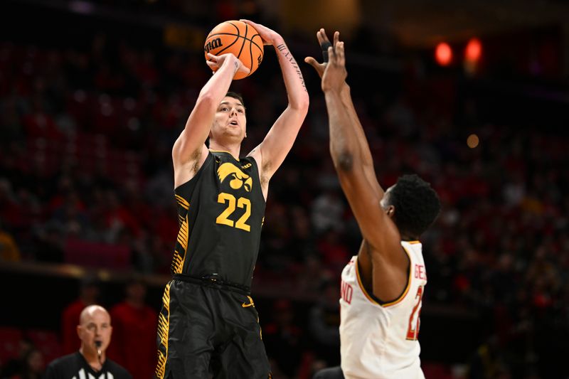 Feb 14, 2024; College Park, Maryland, USA;  Iowa Hawkeyes forward Patrick McCaffery (22) shoots over Maryland Terrapins forward Jordan Geronimo (22) durnig the fist half at Xfinity Center. Mandatory Credit: Tommy Gilligan-USA TODAY Sports