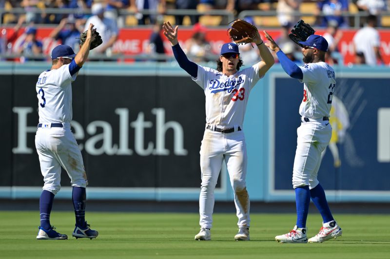 Sep 3, 2023; Los Angeles, California, USA; Los Angeles Dodgers left fielder Chris Taylor (3) and center fielder James Outman (33) and right fielder Jason Heyward (23) celebrate after the final out of the ninth inning against the Atlanta Braves at Dodger Stadium. Mandatory Credit: Jayne Kamin-Oncea-USA TODAY Sports