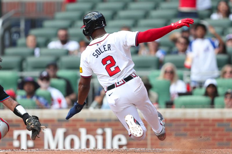 Aug 4, 2024; Cumberland, Georgia, USA; Atlanta Braves designated hitter Jorge Soler (2) slides into home in the third inning during the game against Miami Marlins at Truist Park. Mandatory Credit: Mady Mertens-USA TODAY Sports