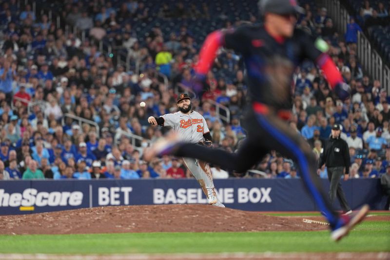 Sep 12, 2025; Toronto, Ontario, CAN; Baltimore Orioles third baseman Emmanuel Rivera (26) throws to first base unable to get Toronto Blue Jays left fielder Myles Straw (3) out during the eighth inning at Rogers Centre. Mandatory Credit: Nick Turchiaro-Imagn Images