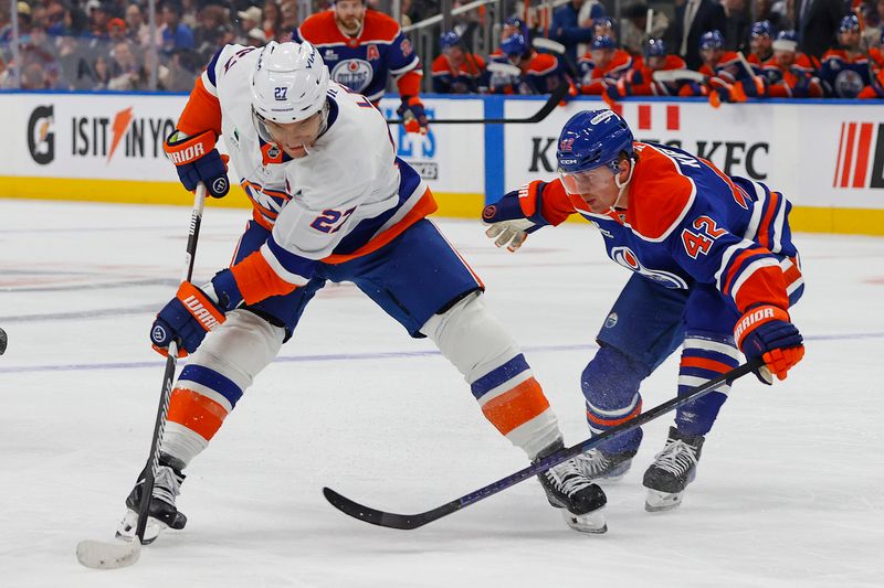 Jan 15, 2026; Edmonton, Alberta, CAN; Edmonton Oilers forward Kasperi Kapanen (42) knocks the puck away from New York Islanders forward Anders Lee (27) during the second period at Rogers Place. Mandatory Credit: Perry Nelson-Imagn Images