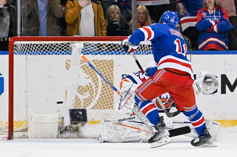 Apr 13, 2024; New York, New York, USA;  New York Rangers center Vincent Trocheck (16) scores the game clinching goal against the New York Islanders during shoot outs at Madison Square Garden. Mandatory Credit: Dennis Schneidler-USA TODAY Sports