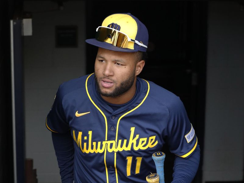 May 25, 2025; Pittsburgh, Pennsylvania, USA;  Milwaukee Brewers center fielder Jackson Chourio (11) enters the dugout to play the Pittsburgh Pirates at PNC Park. Mandatory Credit: Charles LeClaire-Imagn Images