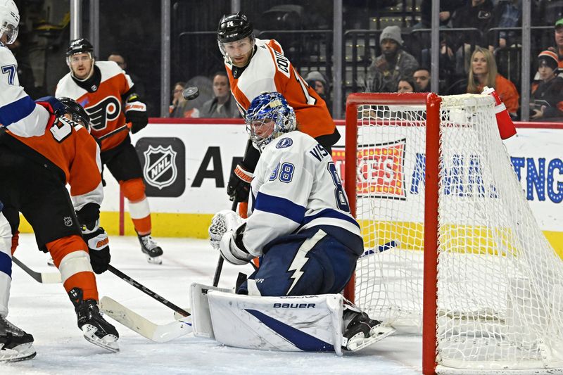 Jan 23, 2024; Philadelphia, Pennsylvania, USA; Tampa Bay Lightning goaltender Andrei Vasilevskiy (88) makes a save was Philadelphia Flyers center Sean Couturier (14) looks on during the third period at Wells Fargo Center. Mandatory Credit: Eric Hartline-USA TODAY Sports