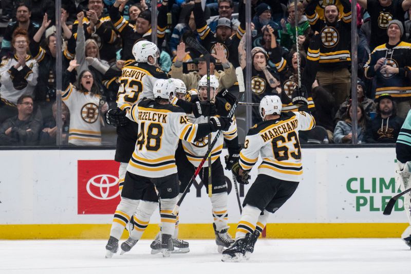 Feb 23, 2023; Seattle, Washington, USA; Boston Bruins players including defenseman Charlie McAvoy (73), defenseman Matt Grzelcyk (48), forward Patrice Bergeron (37) and forward Brad Marchand (63) celebrate a goal during the third period against the Seattle Kraken at Climate Pledge Arena. Mandatory Credit: Stephen Brashear-USA TODAY Sports