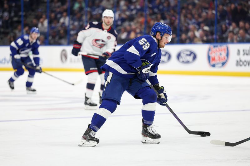 Mar 4, 2025; Tampa, Florida, USA; Tampa Bay Lightning center Jake Guentzel (59) controls the puck against the Columbus Blue Jackets in the second period at Amalie Arena. Mandatory Credit: Nathan Ray Seebeck-Imagn Images