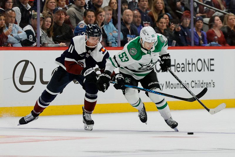 Oct 11, 2025; Denver, Colorado, USA; Colorado Avalanche center Brock Nelson (11) and Dallas Stars center Wyatt Johnston (53) battle for the puck in the third period at Ball Arena. Mandatory Credit: Isaiah J. Downing-Imagn Images