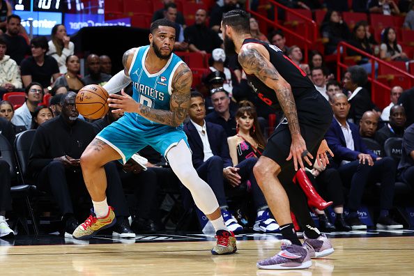 MIAMI, FLORIDA - DECEMBER 13: Miles Bridges #0 of the Charlotte Hornets drives against Caleb Martin #16 of the Miami Heat during the fourth quarter of the game at Kaseya Center on December 13, 2023 in Miami, Florida. NOTE TO USER: User expressly acknowledges and agrees that, by downloading and or using this photograph, User is consenting to the terms and conditions of the Getty Images License Agreement. (Photo by Megan Briggs/Getty Images)