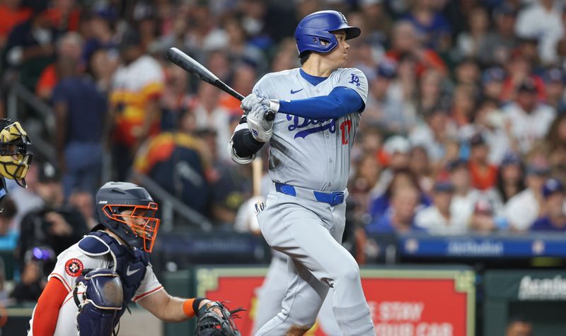 Jul 27, 2024; Houston, Texas, USA; Los Angeles Dodgers designated hitter Shohei Ohtani (17) hits an RBI single during the sixth inning against the Houston Astros at Minute Maid Park. Mandatory Credit: Troy Taormina-USA TODAY Sports