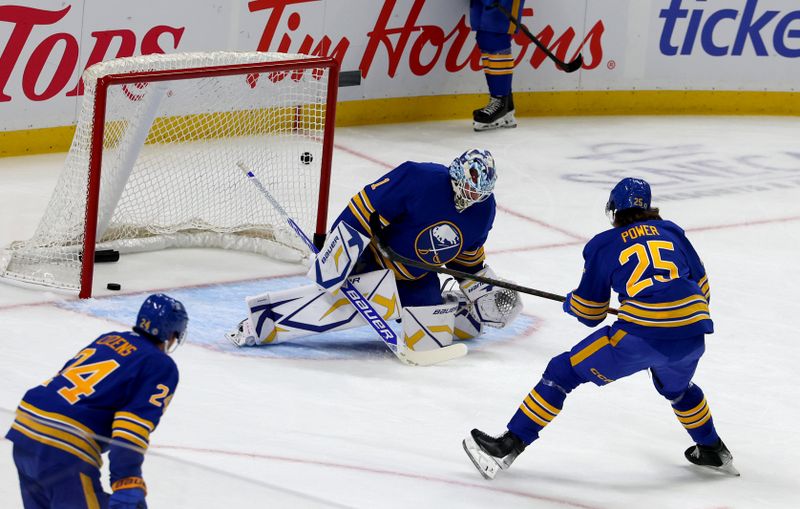 Sep 21, 2024; Buffalo, New York, USA;  Buffalo Sabres goaltender Ukko-Pekka Luukkonen (1) makes a save on defenseman Owen Power (25) before a game against the Pittsburgh Penguins at KeyBank Center. Mandatory Credit: Timothy T. Ludwig-Imagn Images