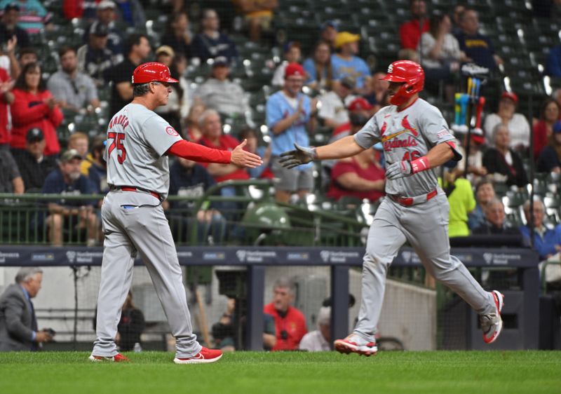 Sep 3, 2024; Milwaukee, Wisconsin, USA; St. Louis Cardinals first base Paul Goldschmidt (46) is congratulated by St. Louis Cardinals third base coach Ron 'Pop' Warner (75) after hitting a home run against the Milwaukee Brewers in the fourth inning at American Family Field. Mandatory Credit: Michael McLoone-Imagn Images