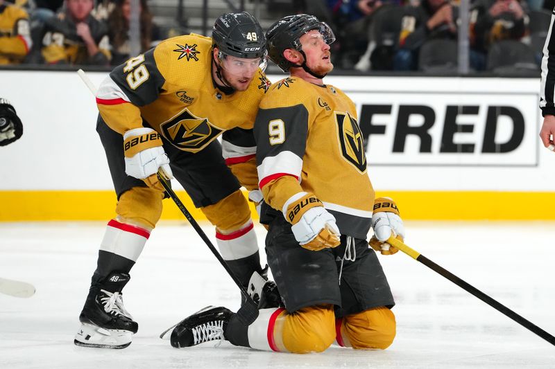 Jan 11, 2024; Las Vegas, Nevada, USA; Vegas Golden Knights center Jack Eichel (9) is pushed off the ice by Vegas Golden Knights center Ivan Barbashev (49) after losing a skate blade while playing against the Boston Bruins during the second period at T-Mobile Arena. Mandatory Credit: Stephen R. Sylvanie-USA TODAY Sports