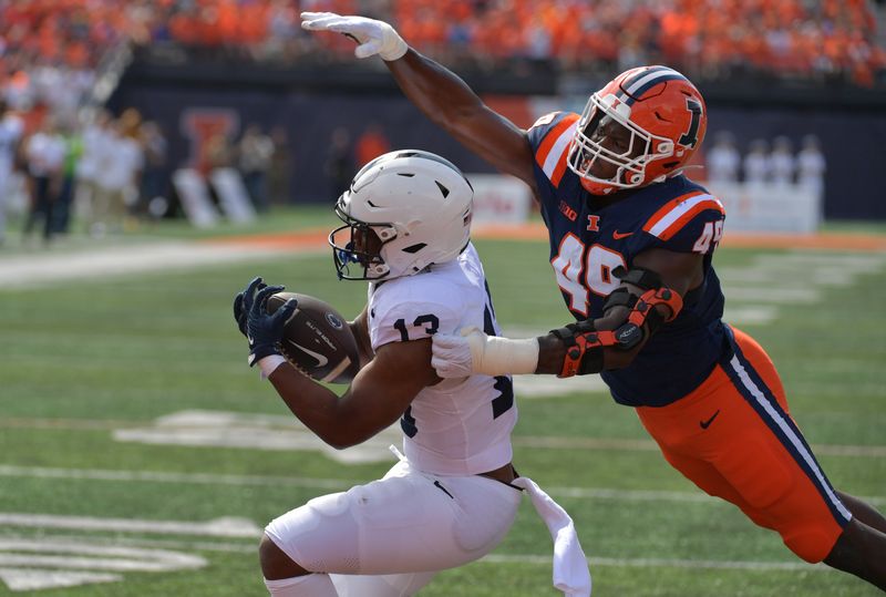 Sep 16, 2023; Champaign, Illinois, USA;  Penn State Nittany Lions running back Kaytron Allen (13) cannot make a catch against Illinois Fighting Illini linebacker Seth Coleman (49) during the first half at Memorial Stadium. Mandatory Credit: Ron Johnson-USA TODAY Sports