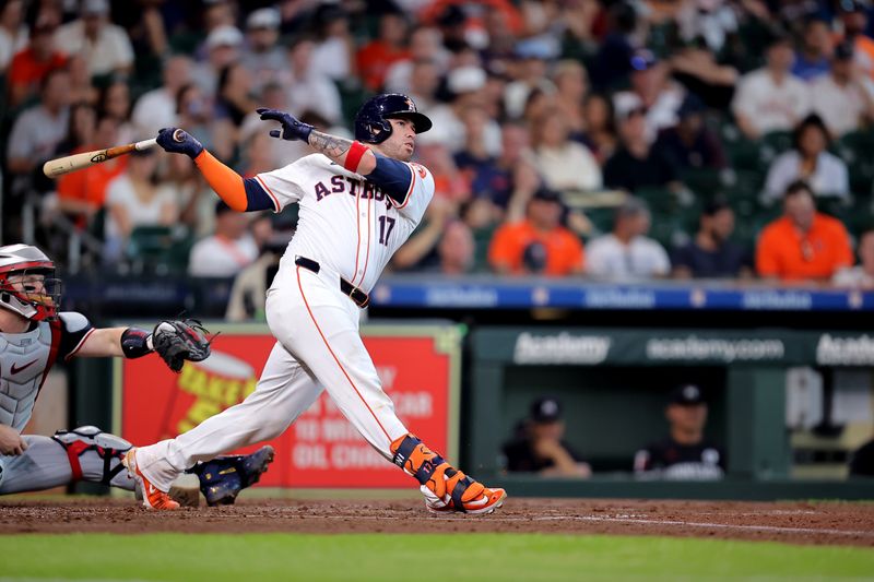 Jun 2, 2024; Houston, Texas, USA; Houston Astros catcher Victor Caratini (17) hits a home run to right field against the Minnesota Twins during the second inning during the second inning at Minute Maid Park. Mandatory Credit: Erik Williams-USA TODAY Sports