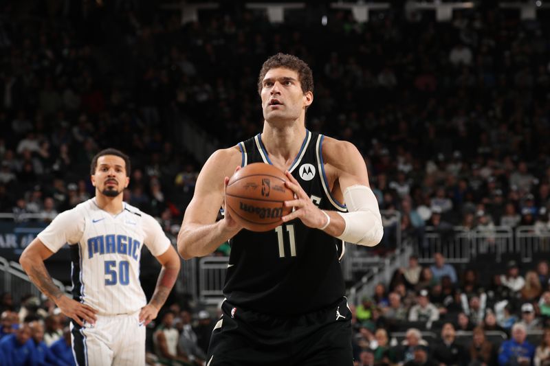 MILWAUKEE, WI - JANUARY 15:  Brook Lopez #11 of the Milwaukee Bucks shoots a free throw during the game against the Orlando Magic on January 15, 2025 at Fiserv Forum Center in Milwaukee, Wisconsin. NOTE TO USER: User expressly acknowledges and agrees that, by downloading and or using this Photograph, user is consenting to the terms and conditions of the Getty Images License Agreement. Mandatory Copyright Notice: Copyright 2025 NBAE (Photo by Gary Dineen/NBAE via Getty Images).