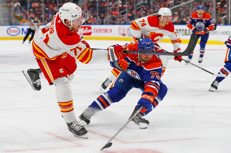 Sep 23, 2024; Edmonton, Alberta, CAN; Calgary Flames forward Walker Duehr (71) shoots in front of Edmonton Oilers defensemen Connor Corcoran (79) during the second period at Rogers Place. Mandatory Credit: Perry Nelson-Imagn Images