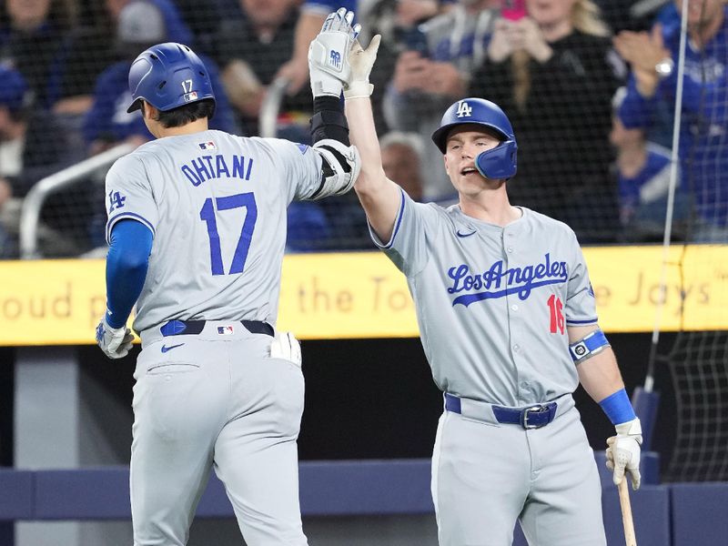 Apr 26, 2024; Toronto, Ontario, CAN; Los Angeles Dodgers designated hitter Shohei Ohtani (17) hits a home run and celebrates with Los Angeles Dodgers catcher Will Smith (16) against the Toronto Blue Jays during the first inning at Rogers Centre. Mandatory Credit: Nick Turchiaro-USA TODAY Sports