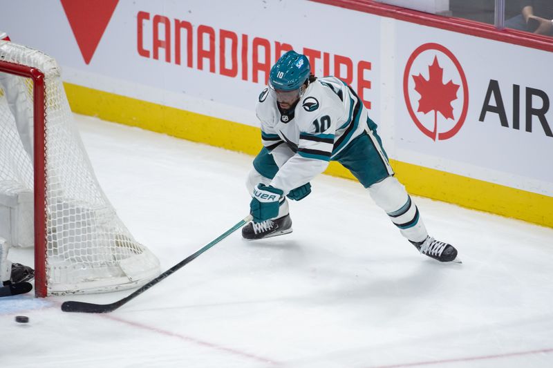 Jan 13, 2024; Ottawa, Ontario, CAN; San Jose Sharks left wing Anthony Duclair (10) tries the wraparound shot in. the third period against the  Ottawa Senators at the Canadian Tire Centre. Mandatory Credit: Marc DesRosiers-USA TODAY Sports