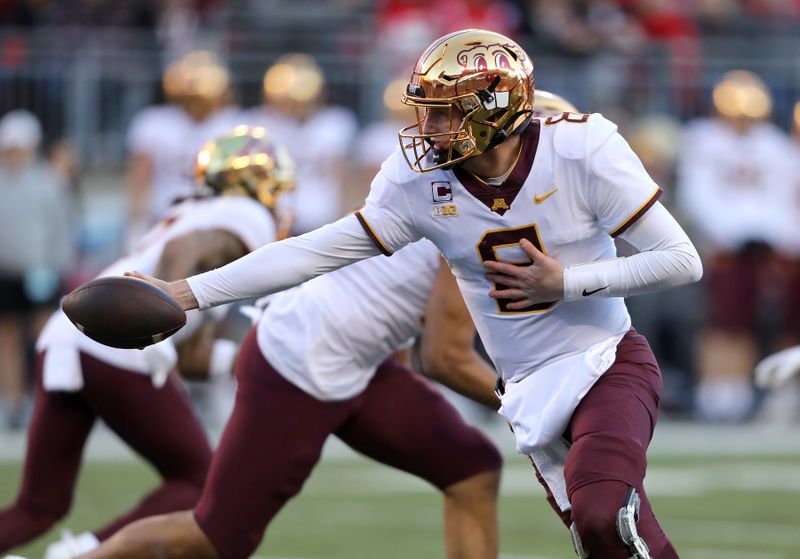 Nov 18, 2023; Columbus, Ohio, USA;  Minnesota Golden Gophers quarterback Athan Kaliakmanis (8) hands off the ball during the first quarter against the Ohio State Buckeyes at Ohio Stadium. Mandatory Credit: Joseph Maiorana-USA TODAY Sports