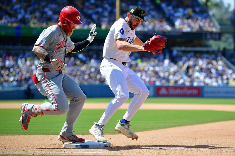 May 19, 2024; Los Angeles, California, USA; Los Angeles Dodgers pitcher Alex Vesia (51) tags first for the out against Cincinnati Reds right fielder Jake Fraley (27) during the eighth inning at Dodger Stadium. Mandatory Credit: Gary A. Vasquez-USA TODAY Sports