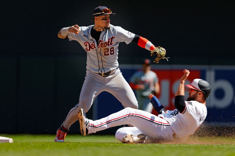 Apr 21, 2024; Minneapolis, Minnesota, USA; Detroit Tigers shortstop Javier Baez (28) forces out Minnesota Twins designated hitter Alex Kirilloff (19) but cannot complete the double play in the fourth inning at Target Field. Mandatory Credit: Bruce Kluckhohn-USA TODAY Sports