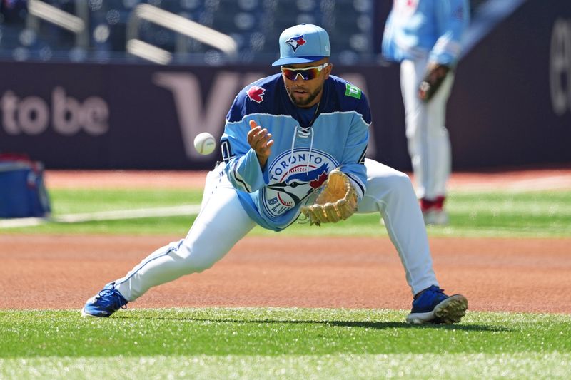 Aug 7, 2024; Toronto, Ontario, CAN; Toronto Blue Jays outfielder Steward Berroa (37) fields balls during batting practice wearing a George Springer replica hockey jersey before a game against the Baltimore Orioles at Rogers Centre. Mandatory Credit: Nick Turchiaro-USA TODAY Sports