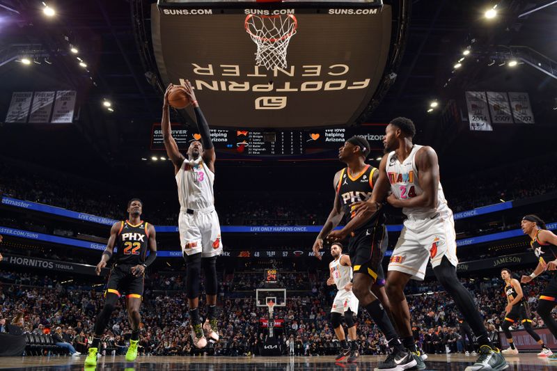 PHOENIX, AZ - JANUARY 6: Bam Adebayo #13 of the Miami Heat rebounds the ball during the game against the Phoenix Suns on January 6, 2023 at Footprint Center in Phoenix, Arizona. NOTE TO USER: User expressly acknowledges and agrees that, by downloading and or using this photograph, user is consenting to the terms and conditions of the Getty Images License Agreement. Mandatory Copyright Notice: Copyright 2022 NBAE (Photo by Barry Gossage/NBAE via Getty Images)