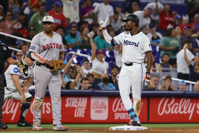 Jul 4, 2024; Miami, Florida, USA; Miami Marlins right fielder Jesus Sanchez (12) reacts from third base after hitting a triple against the Boston Red Sox during the seventh inning at loanDepot Park. Mandatory Credit: Sam Navarro-USA TODAY Sports