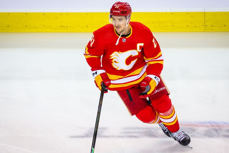 Mar 4, 2024; Calgary, Alberta, CAN; Calgary Flames center Mikael Backlund (11) skates during the warmup period against the Seattle Kraken at Scotiabank Saddledome. Mandatory Credit: Sergei Belski-USA TODAY Sports