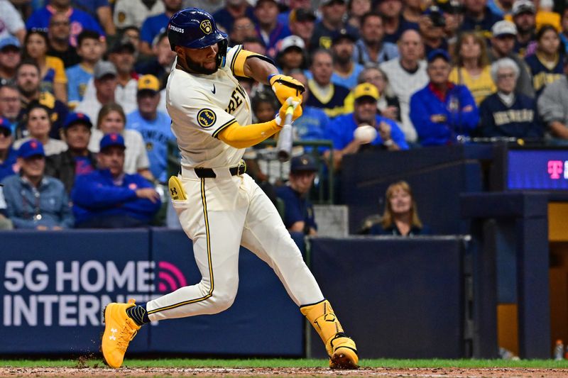 Oct 1, 2024; Milwaukee, Wisconsin, USA; Milwaukee Brewers outfielder Jackson Chourio (11) hits a RBI double against the New York Mets during the fourth inning in game one of the Wildcard round for the 2024 MLB Playoffs at American Family Field. Mandatory Credit: Benny Sieu-Imagn Images